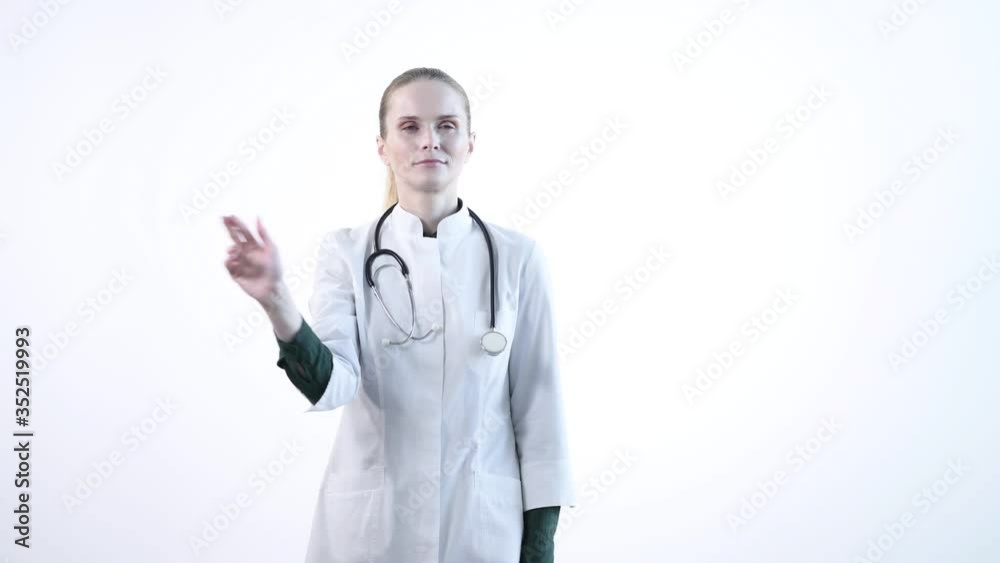 A young specialist in medicine flips an interactive panel. The medicine of the future. A young specialist in medicine flips an interactive panel. The medicine of the future.