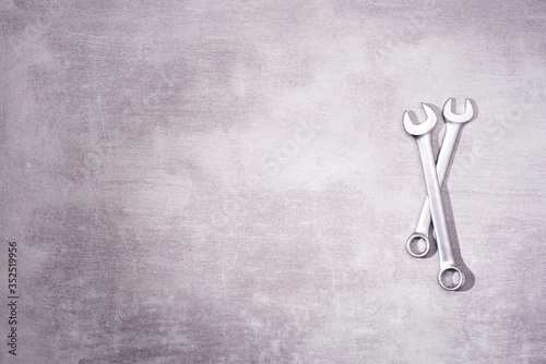 Two metal wrenches on a gray background with place for text, top view © Natallia