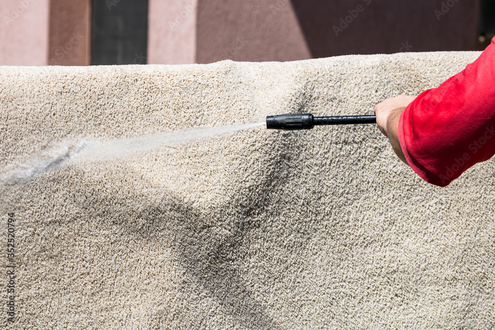 Close up of washing carpets with high pressure washer. Cleaning the carpet  with a gun for washing high pressure water. House cleaning concept. Stock  Photo | Adobe Stock