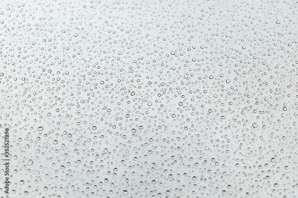 beautiful raindrops on glass window while raining with different texture blurred background. beautiful raindrops on glass window while raining with different texture blurred background.
