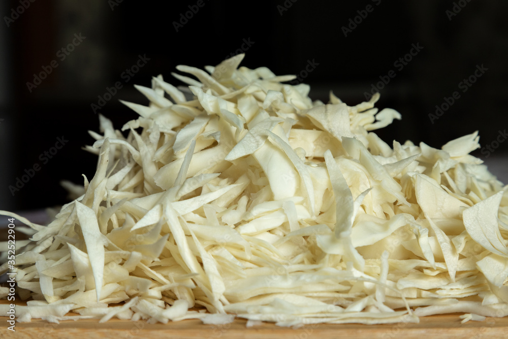 Fresh cabbage. Shredded. Cabbage on the table. Cabbage close up. On a cutting board Fresh cabbage. Shredded. Cabbage on the table. Cabbage close up. On a cutting board
