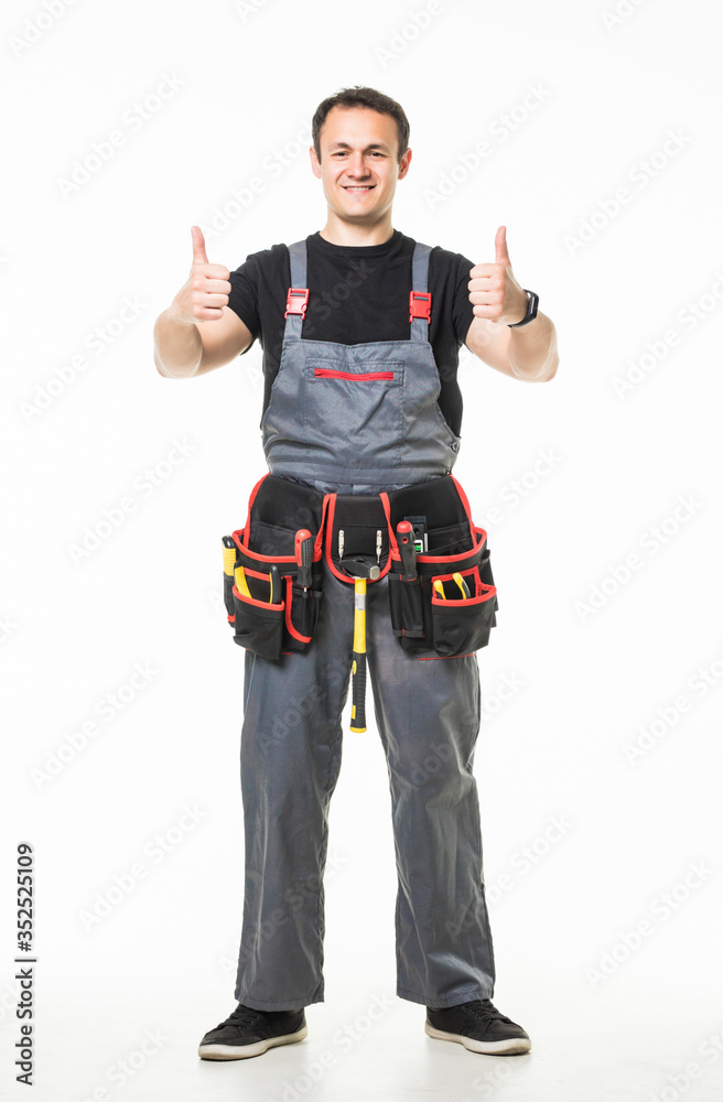Portrait of happy handyman with tools showing thumbs up sign on white background Portrait of happy handyman with tools showing thumbs up sign on white background