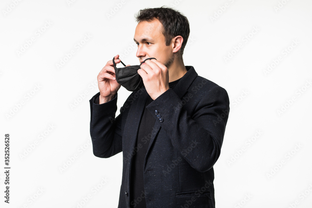 Young man in casual suit wearing respirator mask isolated on white background. Young man in casual suit wearing respirator mask isolated on white background.