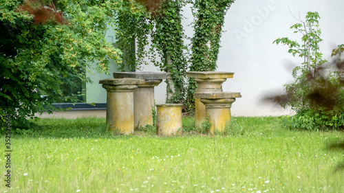 old stone pillars in the garden photo