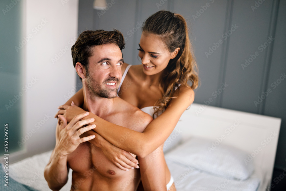 Attractive sexy woman with her handsome partner in bedroom Attractive sexy woman with her handsome partner in bedroom