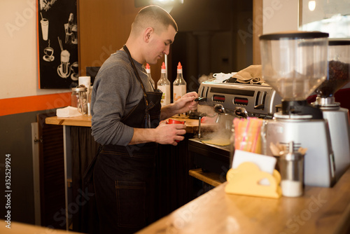 Fototapeta Naklejka Na Ścianę i Meble -  Barista making cappuccino, bartender preparing coffee drink
