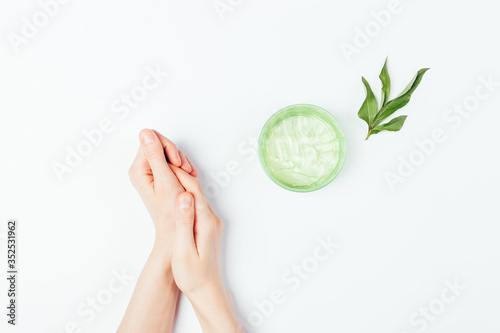 Female hands apply moisturizing skin care gel