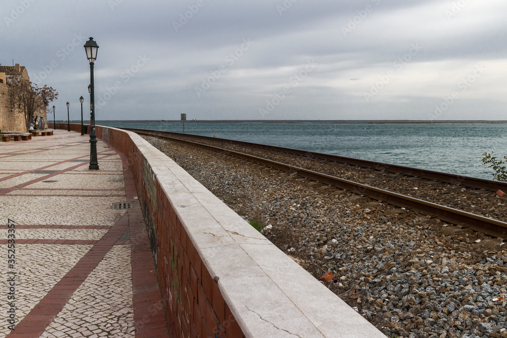 Railway between the promenade and the ocean, Faro, Algarve, Portugal. 