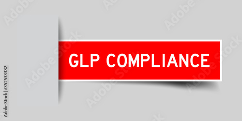 Inserted red color sticker label with word GLP (Good Laboratory Practice) compliance on gray background