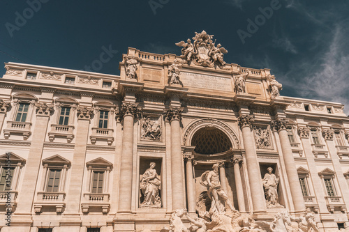 fontana di trevi in rom with blue sky and summer vibes