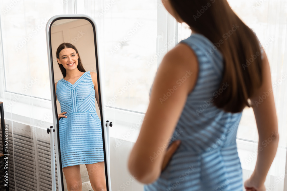 Girl In New Dress Looking At Mirror Posing At Home