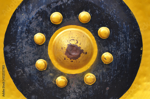 A close-up shot of a large Thai gong, which is an ancient Thai musical instrumen photo