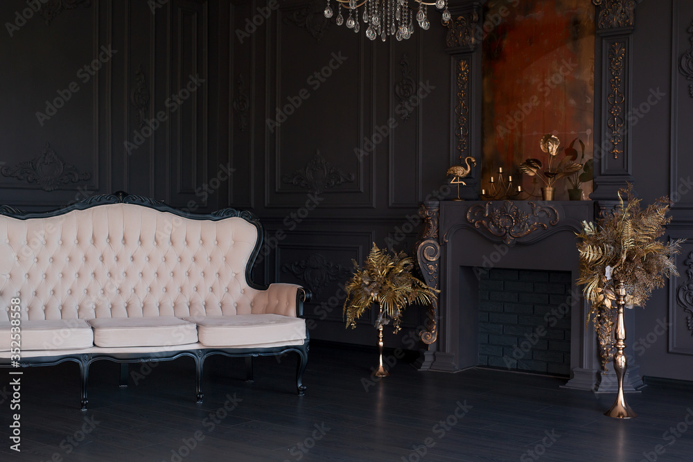 Fototapeta premium Black room interior with a vintage sofa, chandelier, mirror and fireplace