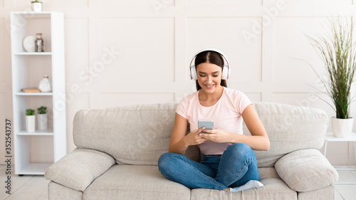 Student Girl With Smartphone Listening To Podcast At Home, Panorama © Prostock-studio