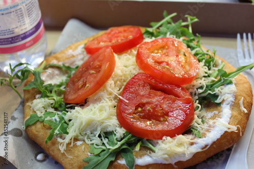 Langós mit Rucola und Tomaten