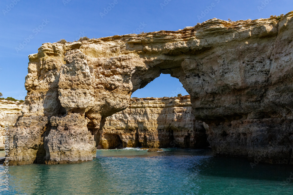 Caves and arches in the rock formations along the coastline, Algarve, Portugal.