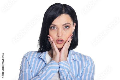 Portrait of beautiful young woman posing against white background photo