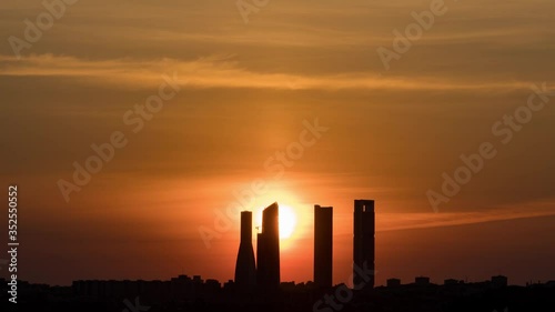 Night to day Time Lapse of a sunrise in Madrid 4 Towers. Skyline silhouette in 4K. photo