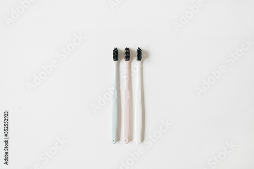 Oral care toothbrushes on white background. Flat lay  top view minimal dental hygiene concept