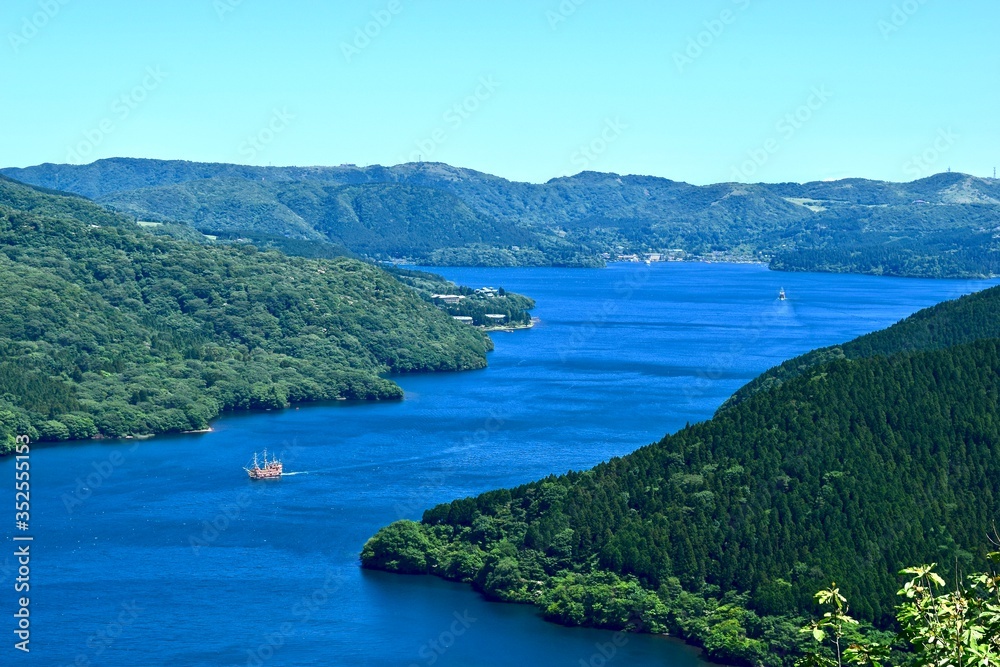 The view of Japanese lake with pleasure boat.