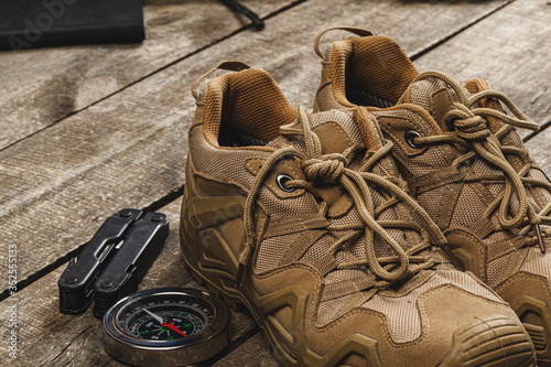 Close up photo of hiking boots and utility knife photo