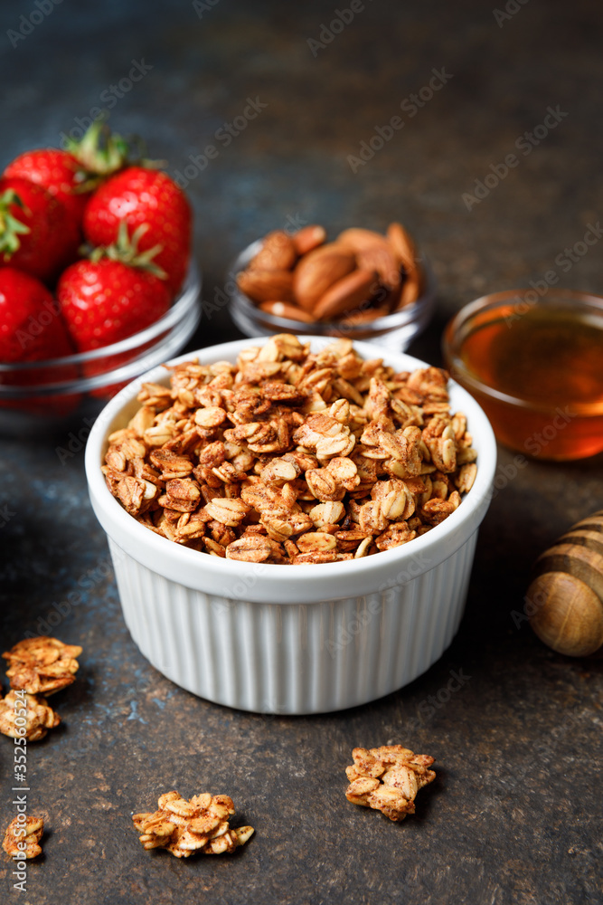 Homemade oatmeal granola bowl with berries on dark background. Homemade oatmeal granola bowl with berries on dark background.