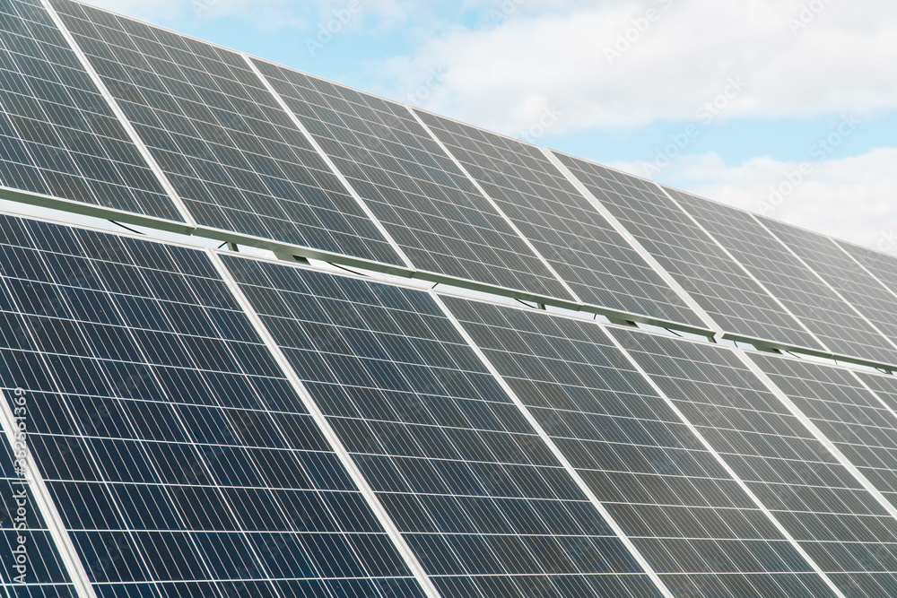Solar panels on the blue sky background. Concept of green energy, clean energy, renewable energy Solar panels on the blue sky background. Concept of green energy, clean energy, renewable energy