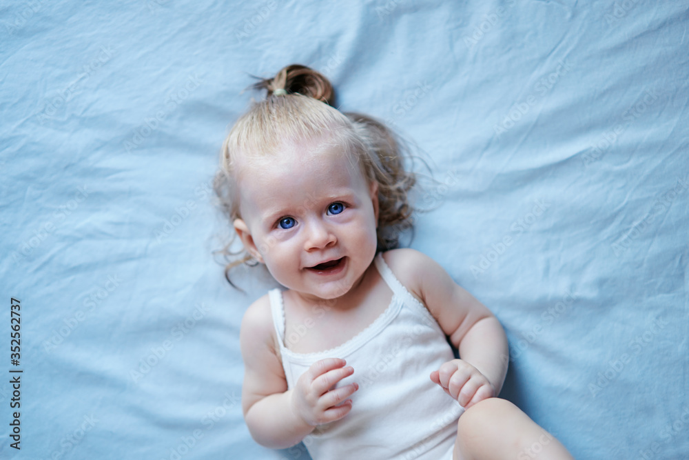 Adorable happy baby girl lying on the bed. Adorable happy baby girl lying on the bed.