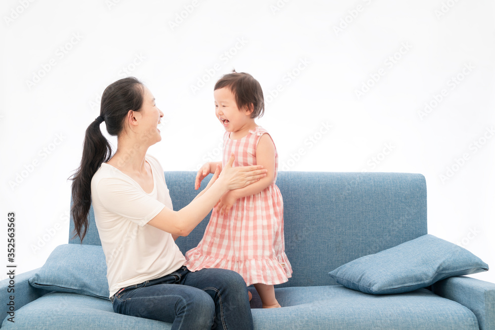 Mother and daughter are playing games on the sofa Mother and daughter are playing games on the sofa