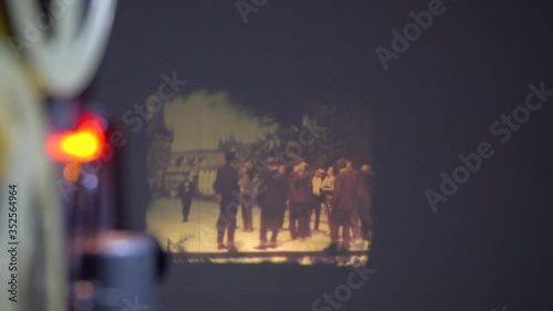 Film runs through an 8mm projector. Old projector shows a movie with an old Prague 60s