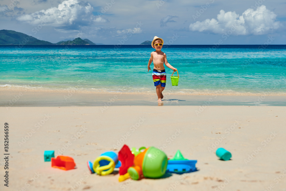 Three year old toddler playing on beach Three year old toddler playing on beach