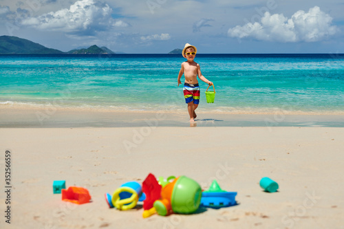 Wallpaper Mural Three year old toddler playing on beach Torontodigital.ca