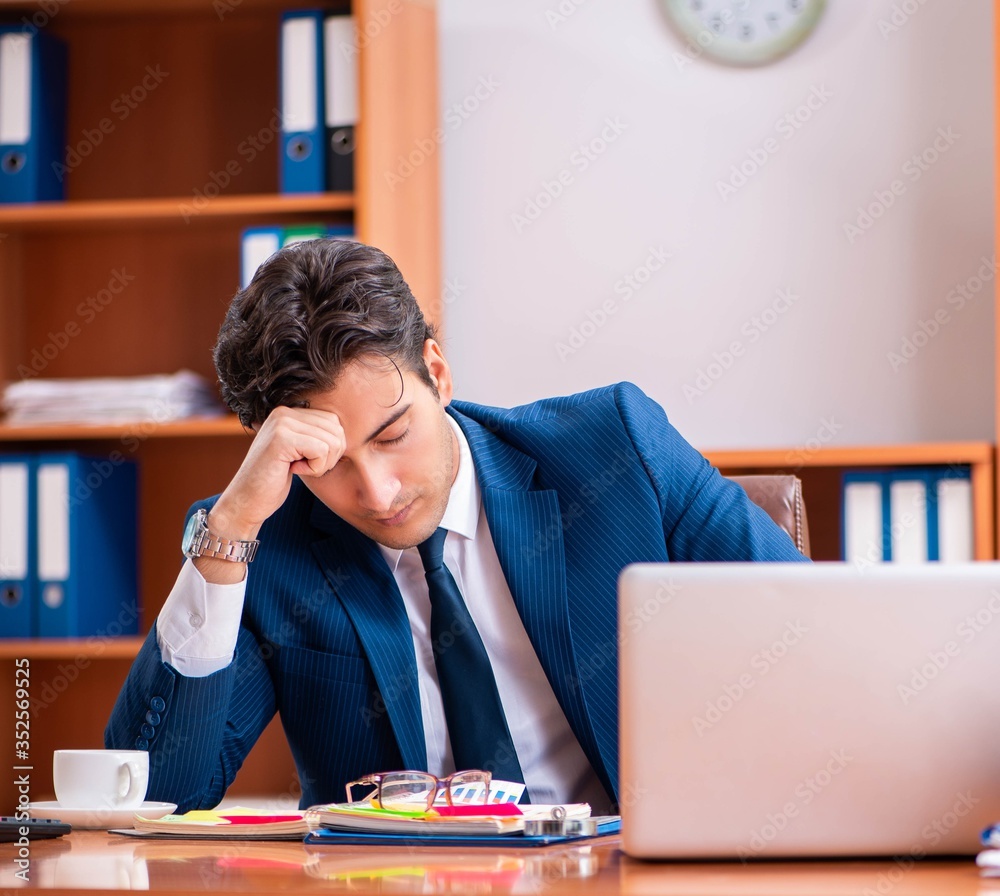 Young handsome businessman working in the office