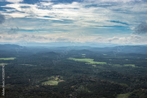 mountain horizon coverd with cloud layers and forests photo