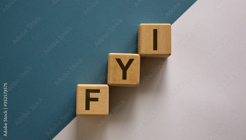 Wood block with acronym 'FYI' - 'for your information' stacking as step stair on paper blue and white background, copy space. Business concept. Wood block with acronym 'FYI' - 'for your information' stacking as step stair on paper blue and white background, copy space. Business concept.