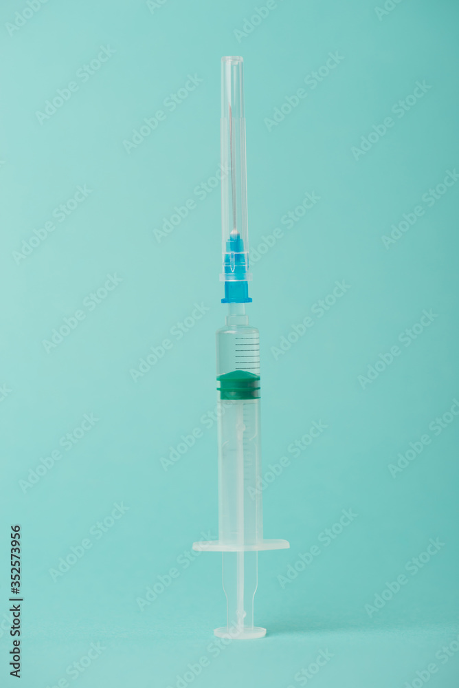 Vertical close-up photo of a covered shot isolated on teal turquoise background