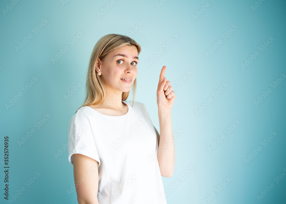 Look up gesture. Portrait of joyful woman with forefinger points up. Banner ad concept Look up gesture. Portrait of joyful woman with forefinger points up. Banner ad concept