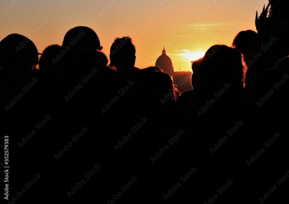 People in front of the sunset