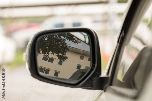 The left side mirror of the car To look at the environment around the car while driving on the road © chaiphoto1