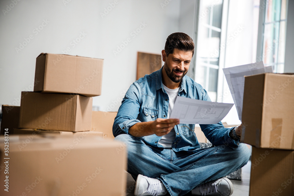 Cheerful bearded man moving to new apartment Cheerful bearded man moving to new apartment