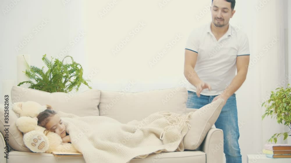Little daughter sleeping on the white coach.