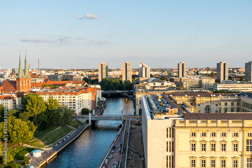 Cityscape of downtown of Berlin with modern skylines and  tower of St. Nicholas' Church under sunset. Aerial view from Berlin Cathedral.