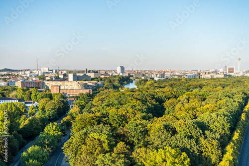 Panoramic city view of Berlin, viewfrom the top of the Berlin Victory Column in Tiergarten, Berlin, with modern skylines and green forest. © zz3701