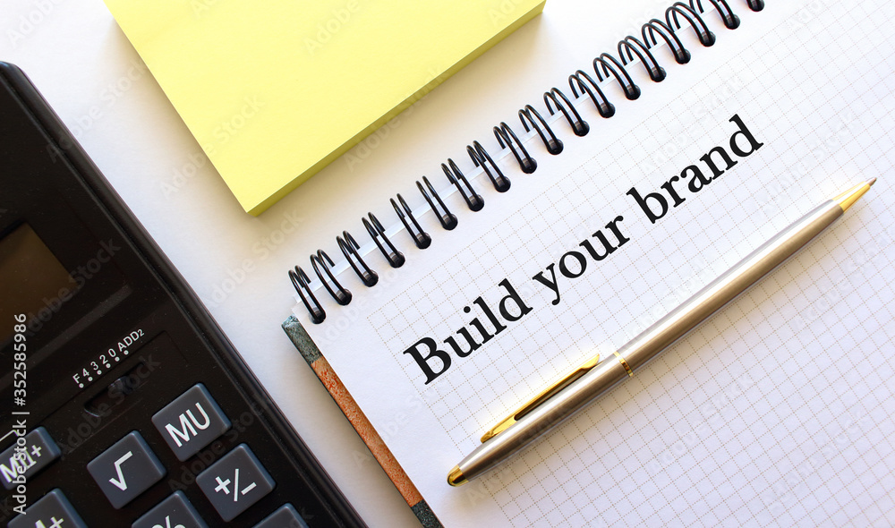 notebook with the inscription, calculator, pen lying on a white table notebook with the inscription, calculator, pen lying on a white table