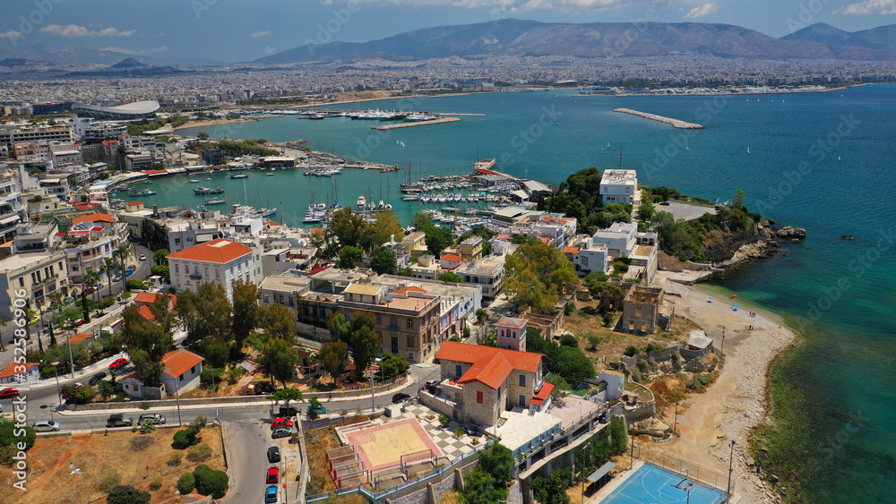 Aerial drone bird's eye view panoramic photo of iconic round shaped picturesque port of Mikrolimano with sail boats and yachts docked, Piraeus port, Attica, Greece