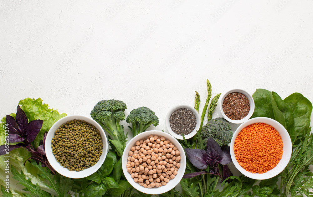 Source of protein for vegetarians. Frame of healthy clean food: vegetables, seeds, leafy vegetable on a white background Source of protein for vegetarians. Frame of healthy clean food: vegetables, seeds, leafy vegetable on a white background