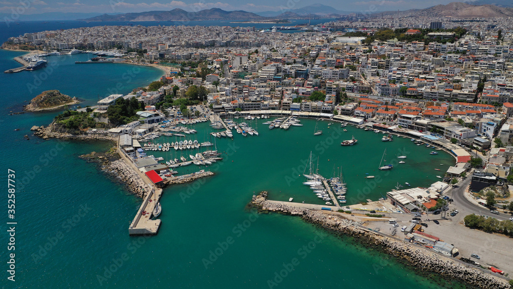 Aerial drone bird's eye view panoramic photo of iconic round shaped picturesque port of Mikrolimano with sail boats and yachts docked, Piraeus port, Attica, Greece