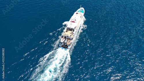 Aerial drone photo of yacht cruising in high speed in open ocean Aegean deep blue sea, Greece © aerial-drone
