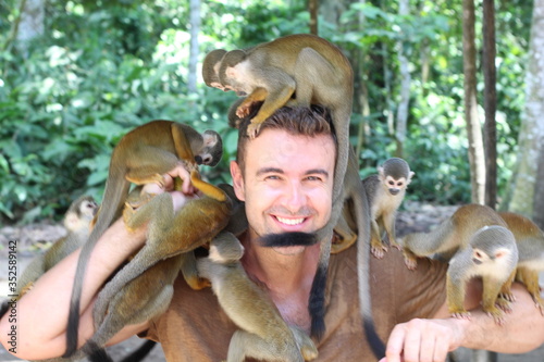 Man with a group of wild monkeys