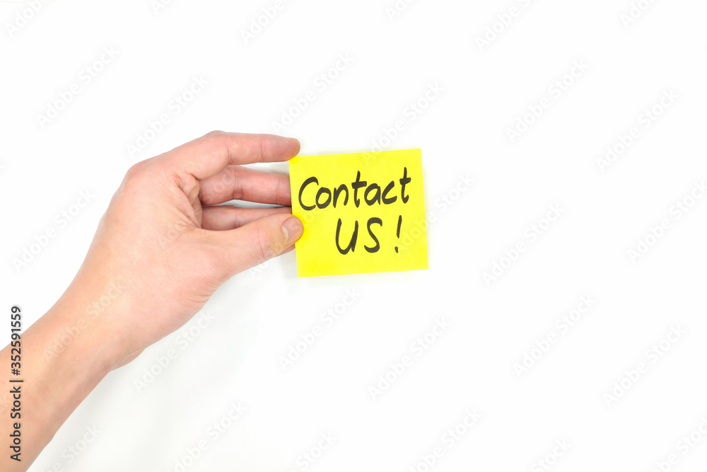 Young male hand holding bright yellow contact us card isolated in white background. Young male hand holding bright yellow contact us card isolated in white background.